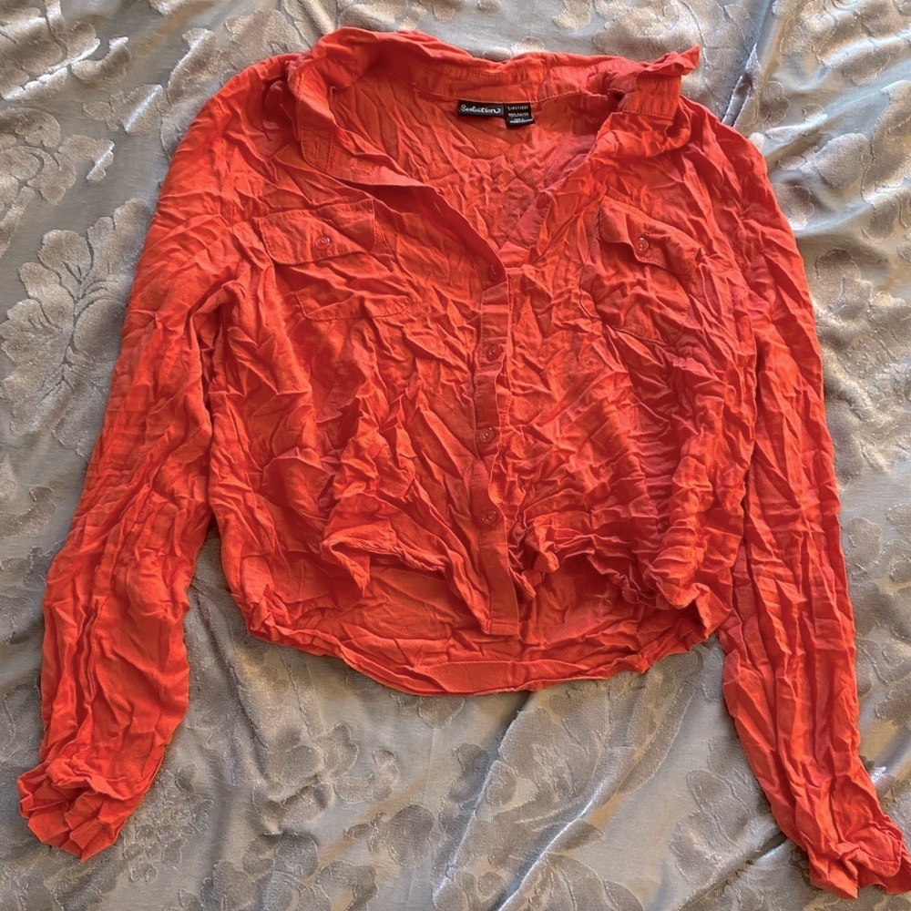 Orange short button up blouse.